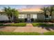 Charming villa with well-maintained landscaping, lush green lawn and mature palm trees at 3410 Stonehaven E Ct # A, Palm Harbor, FL 34684