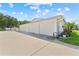Three-car garage with white doors and concrete driveway, showcasing ample parking and modern design at 3410 Stonehaven E Ct # A, Palm Harbor, FL 34684