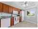 Kitchen with wooden cabinets, tile floors and white appliances at 3410 Stonehaven E Ct # A, Palm Harbor, FL 34684