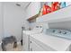 Functional laundry room with white washer and dryer and storage cabinets, for all your laundry needs at 3410 Stonehaven E Ct # A, Palm Harbor, FL 34684