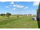 Spacious backyard area with a clear view of the neighborhood and green space at 34248 Redwood Dawn Ln, Wesley Chapel, FL 33543