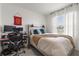 Comfortable bedroom with a well-lit window and a desk area at 34248 Redwood Dawn Ln, Wesley Chapel, FL 33543
