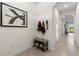 Welcoming entryway features neutral tile flooring, bench, and modern wall art to create a comfortable space at 34248 Redwood Dawn Ln, Wesley Chapel, FL 33543