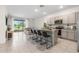 Open-concept kitchen features a large island with barstool seating and overlooks the living area at 34248 Redwood Dawn Ln, Wesley Chapel, FL 33543