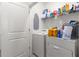 Functional laundry room featuring a washer, dryer, and ample storage space at 34248 Redwood Dawn Ln, Wesley Chapel, FL 33543