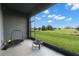 Covered patio features views of the lawn and beautiful landscape at 34248 Redwood Dawn Ln, Wesley Chapel, FL 33543