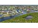 Beautiful aerial view of the waterfront homes with private boat docks, perfectly situated among lush trees at 3936 Crooked Island Dr, Punta Gorda, FL 33950