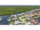 Aerial view of waterfront home featuring a private boat dock, lush greenery and beautiful surroundings at 3936 Crooked Island Dr, Punta Gorda, FL 33950