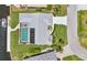 Aerial view of a waterfront home featuring a boat dock, pool with screened enclosure, and manicured lawn at 3936 Crooked Island Dr, Punta Gorda, FL 33950