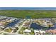 An aerial view of a waterfront neighborhood with canals, beautiful landscaping, and nearby ocean access at 3936 Crooked Island Dr, Punta Gorda, FL 33950