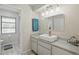 Bright bathroom featuring a modern vessel sink, decorative lighting, and a tiled floor at 3936 Crooked Island Dr, Punta Gorda, FL 33950