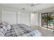 Bedroom with pool access, tiled floor, ceiling fan, and ample closet space at 3936 Crooked Island Dr, Punta Gorda, FL 33950