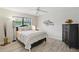 Bedroom featuring new floors, a ceiling fan, and a large window at 3936 Crooked Island Dr, Punta Gorda, FL 33950