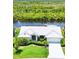 Stunning waterfront home with lush landscaping, bright white exterior, and private dock at 3936 Crooked Island Dr, Punta Gorda, FL 33950