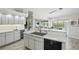 Bright kitchen with white cabinetry, modern appliances, ample counter space, and serene water views at 3936 Crooked Island Dr, Punta Gorda, FL 33950
