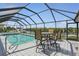 Large screened-in pool area featuring an outdoor dining set, providing beautiful waterfront views at 3936 Crooked Island Dr, Punta Gorda, FL 33950