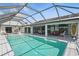 The screen-enclosed pool boasts ample room to relax plus extra patio seating near the home's interior at 3936 Crooked Island Dr, Punta Gorda, FL 33950