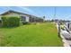 Waterfront property featuring a manicured lawn, access to a boat dock and screened patio at 3936 Crooked Island Dr, Punta Gorda, FL 33950