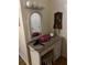 Wicker vanity with mirror and stool providing a classic aesthetic to the bathroom at 405 Bryn Mawr Is, Bradenton, FL 34207