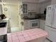 Bright kitchen with white appliances, tile countertops, and a functional layout at 405 Bryn Mawr Is, Bradenton, FL 34207