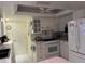 Bright kitchen with white appliances, tile countertops, and a convenient layout at 405 Bryn Mawr Is, Bradenton, FL 34207
