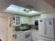 Well-lit kitchen featuring ample cabinetry, modern appliances, and a convenient ceiling fan at 405 Bryn Mawr Is, Bradenton, FL 34207