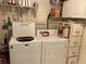 Functional laundry room equipped with a washer, dryer, and storage shelving at 405 Bryn Mawr Is, Bradenton, FL 34207