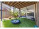 Covered patio with two saucer swings and artificial turf at 4100 Miramar Way, St Petersburg, FL 33705