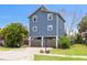 Charming two-story home with light blue siding, white trim, and a beautifully landscaped yard at 4100 Miramar Way, St Petersburg, FL 33705