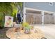 Stylish front yard with a gravel bed, potted plants, decorative ornaments, and a 'Welcome' sign at 4100 Miramar Way, St Petersburg, FL 33705