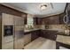 Updated kitchen with stainless steel appliances, granite countertops, and dark wood cabinets at 4100 Miramar Way, St Petersburg, FL 33705