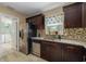 Modern kitchen features stainless steel appliances, granite countertops and tiled backsplash at 4100 Miramar Way, St Petersburg, FL 33705