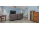 Bright living room featuring pale blue walls, laminate floors, a large TV, and comfortable seating at 4100 Miramar Way, St Petersburg, FL 33705