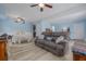 Open-concept living room featuring pale blue walls, laminate floors, dining space, and comfortable seating at 4100 Miramar Way, St Petersburg, FL 33705