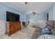 Well-lit living room featuring pale blue walls, laminate floors, a dining space, and comfortable seating at 4100 Miramar Way, St Petersburg, FL 33705