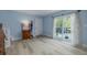 Spacious living room with access to a deck, showcasing pale blue walls, and laminate floors at 4100 Miramar Way, St Petersburg, FL 33705