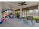 Large, covered patio with multiple seating areas, ceiling fans, and backyard access at 4100 Miramar Way, St Petersburg, FL 33705