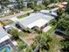Aerial view of charming yellow home, showcasing a fenced yard, canal access, and serene neighborhood at 4200 49Th S Ave, St Petersburg, FL 33711