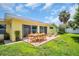 A patio set on a paved patio for outdoor dining in a spacious backyard at 4200 49Th S Ave, St Petersburg, FL 33711