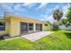 Exterior view of the home with sliding glass doors that open to an outdoor patio at 4200 49Th S Ave, St Petersburg, FL 33711