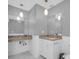 Bright bathroom featuring dual vanities, granite countertops, and classic white cabinets at 4200 49Th S Ave, St Petersburg, FL 33711