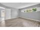 Unfurnished bedroom with wood-look flooring, light gray paint and a sunlit window at 4200 49Th S Ave, St Petersburg, FL 33711