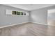 Unfurnished bedroom with wood-look flooring, light gray paint and a sunlit window at 4200 49Th S Ave, St Petersburg, FL 33711
