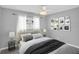 Stylish bedroom features a cozy bed, decorative wall art, and ample natural light at 4200 49Th S Ave, St Petersburg, FL 33711