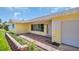 Inviting entrance with brick pathway, yellow accents, and a well-lit walkway to the front door at 4200 49Th S Ave, St Petersburg, FL 33711