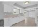 Bright kitchen featuring white cabinetry and a spacious layout with tile flooring at 4200 49Th S Ave, St Petersburg, FL 33711