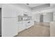 Bright kitchen with white appliances, tile flooring, and an open layout to the living spaces at 4200 49Th S Ave, St Petersburg, FL 33711