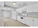 Spacious kitchen with white cabinets and appliances, providing a clean and functional space at 4200 49Th S Ave, St Petersburg, FL 33711