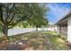 Spacious backyard featuring a white fence and mature trees, offering privacy and shade at 4264 Michaler St, North Port, FL 34286