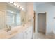 Bright bathroom featuring double vanity, large mirror, and tile flooring at 4264 Michaler St, North Port, FL 34286